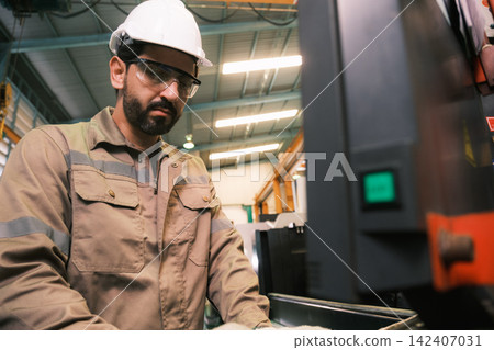 Engineers and workers work in the factory. Engineers and workers work in the factory. 142407031