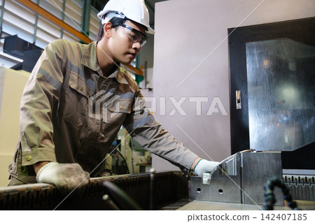Engineers and workers work in the factory. Engineers and workers work in the factory. 142407185