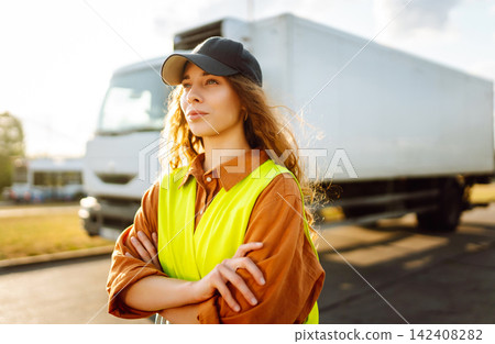 Woman Driver standing near truck. Transport industry theme. Logistic shipping. 142408282