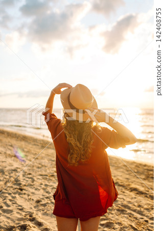 Beautiful woman enjoying a summer day on the beach at sunset. Lifestyle, tourism, active life. Beautiful woman enjoying a summer day on the beach at sunset. Lifestyle, tourism, active life. 142408755