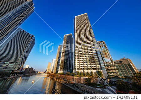 High-rise apartment buildings and cityscapes soaring towards the blue sky. High-rise apartment buildings and cityscapes soaring towards the blue sky. 142409131