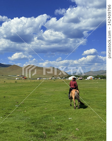 People enjoying horseback riding tours on the vast grasslands outside Ulaanbaatar, Mongolia. People enjoying horseback riding tours on the vast grasslands outside Ulaanbaatar, Mongolia. 142409766