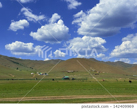 The landscape of vast grasslands and mountains stretching out on the outskirts of Ulaanbaatar, Mongolia. 142409969