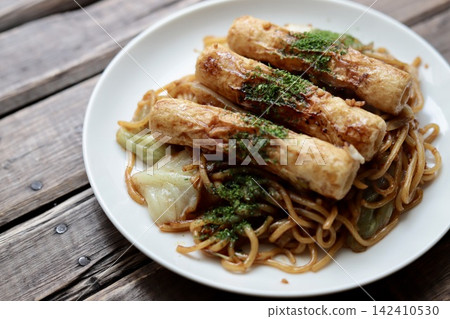 A hearty yakisoba with three whole chikuwa (fish cakes) on top. A hearty yakisoba with three whole chikuwa (fish cakes) on top. 142410530