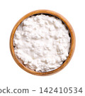 Cottage cheese, type of fresh cheese in wooden bowl, isolated from above. Fresh cheese made from skimmed milk, hence the low milkfat content, with mild flavor and creamy, heterogeneous texture. Photo Cottage cheese, type of fresh cheese in wooden bowl, isolated from above. Fresh cheese made from skimmed milk, hence the low milkfat content, with mild flavor and creamy, heterogeneous texture. Photo 142410534