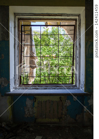 Abandoned Soviet-era Palace of Culture in the former mining settlement of Kukisvumchorr near Kirovsk, Murmansk Region, Russia. The decaying cultural building stands beneath the Khibiny Mountains, surr Abandoned Soviet-era Palace of Culture in the former mining settlement of Kukisvumchorr near Kirovsk, Murmansk Region, Russia. The decaying cultural building stands beneath the Khibiny Mountains, surr 142411459