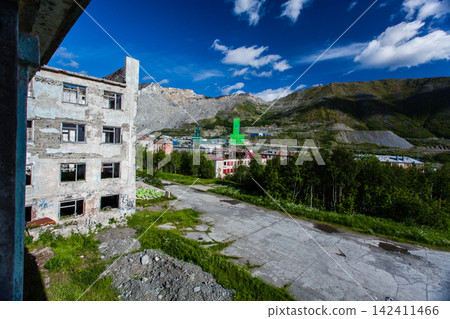 Abandoned Soviet-era Palace of Culture in the former mining settlement of Kukisvumchorr near Kirovsk, Murmansk Region, Russia. The decaying cultural building stands beneath the Khibiny Mountains, surr Abandoned Soviet-era Palace of Culture in the former mining settlement of Kukisvumchorr near Kirovsk, Murmansk Region, Russia. The decaying cultural building stands beneath the Khibiny Mountains, surr 142411466