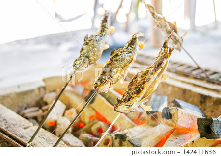 Salt-grilled rainbow trout caught at a fishing pond. Salt-grilled rainbow trout caught at a fishing pond. 142411636