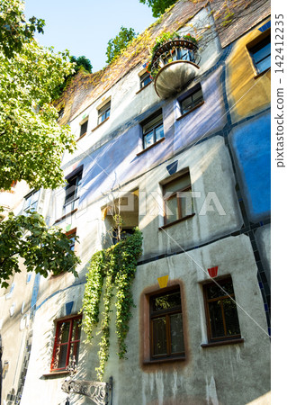 Detail of unique colorful facade of Kunst Haus Wien designed by Friedensreich Hundertwasser Detail of unique colorful facade of Kunst Haus Wien designed by Friedensreich Hundertwasser 142412235