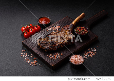 Grilled beef Tomahawk steak seasoned with salt and spices. Tomahawk steak Grilled beef Tomahawk steak seasoned with salt and spices. Tomahawk steak 142412280