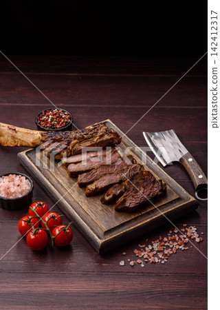 Grilled beef Tomahawk steak seasoned with salt and spices. Tomahawk steak Grilled beef Tomahawk steak seasoned with salt and spices. Tomahawk steak 142412317