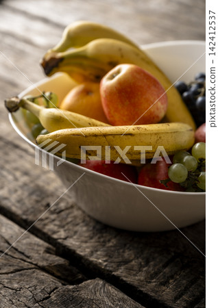 Fresh fruit bowl on rustic wooden table Fresh fruit bowl on rustic wooden table 142412537