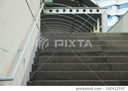 Outdoor staircases leading to public facilities and office buildings, and exposed concrete walls. Outdoor staircases leading to public facilities and office buildings, and exposed concrete walls. 142412597