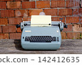 Antique typewriter with inserted paper sheet 142412635