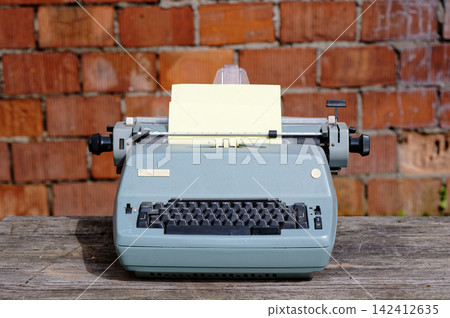 Antique typewriter with inserted paper sheet Antique typewriter with inserted paper sheet 142412635