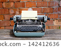 Antique typewriter with inserted paper sheet 142412636