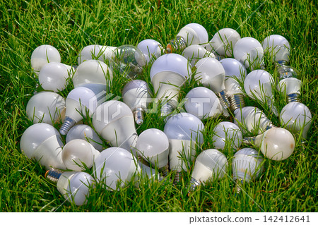 LED lamp bulb on green background LED lamp bulb on green background 142412641