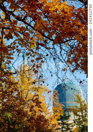 View of Saint Petersburg Blue Mosque through yellow leaves at sunny autumn day, large blue dome, The mosque opened in 1913, was the largest mosque in Europe outside Turkey View of Saint Petersburg Blue Mosque through yellow leaves at sunny autumn day, large blue dome, The mosque opened in 1913, was the largest mosque in Europe outside Turkey 142412730