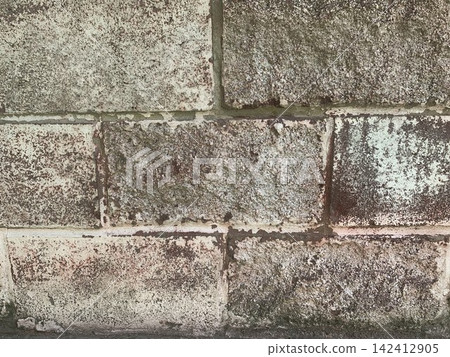 Old weathered concrete cinder block wall texture background with moss and peeling paint Old weathered concrete cinder block wall texture background with moss and peeling paint 142412905