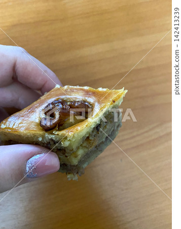Walnut Pastry Held in Hand Walnut Pastry Held in Hand 142413239