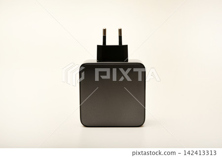Black power supply for a mobile device. Powerful power supplies on a white background. Black power supply for a mobile device. Powerful power supplies on a white background. 142413313