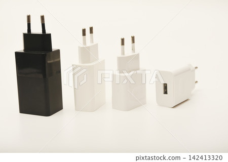 Black and white power supplies for mobile devices. Powerful power supplies on a white background. Charging devices for gadgets. Black and white power supplies for mobile devices. Powerful power supplies on a white background. Charging devices for gadgets. 142413320