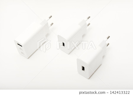 White power supply for a mobile device. Powerful power supplies on a white background. White power supply for a mobile device. Powerful power supplies on a white background. 142413322