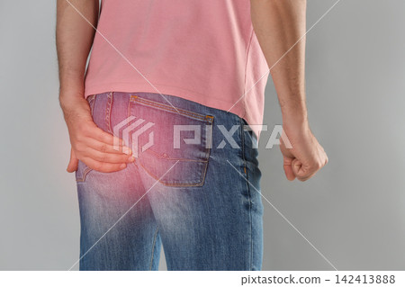 Man suffering from hemorrhoid on light grey background, closeup Man suffering from hemorrhoid on light grey background, closeup 142413888