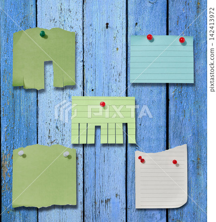 Various paper stickers and tear-off ads pinned to an old blue wooden board. Various paper stickers and tear-off ads pinned to an old blue wooden board. 142413972