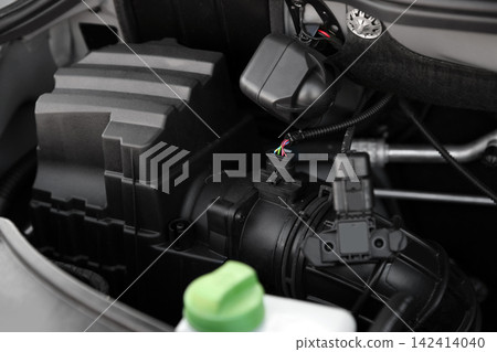 Closeup view of engine bay in modern car Closeup view of engine bay in modern car 142414040