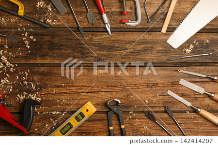 Frame made with carpenter's tools on wooden background, flat lay. Space for text Frame made with carpenter's tools on wooden background, flat lay. Space for text 142414207