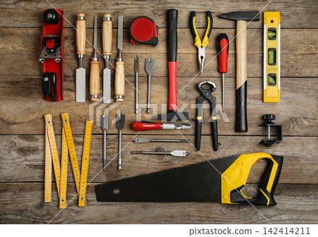 Flat lay composition with carpenter's tools on wooden background Flat lay composition with carpenter's tools on wooden background 142414211