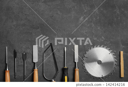 Flat lay composition with carpenter's tools on grey background. Space for text Flat lay composition with carpenter's tools on grey background. Space for text 142414216