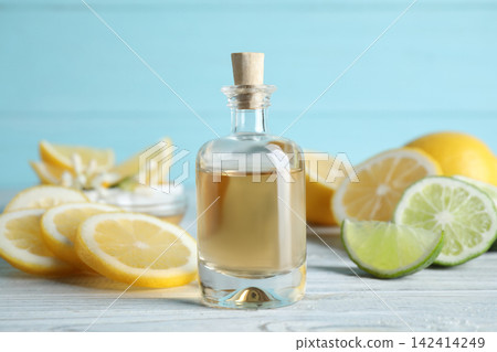 Citrus essential oil on white wooden table Citrus essential oil on white wooden table 142414249