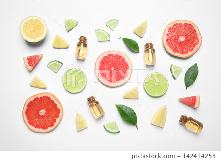 Flat lay composition with bottles of citrus essential oil on white background 142414253