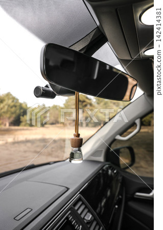 Air freshener hanging on rear view mirror in car Air freshener hanging on rear view mirror in car 142414381