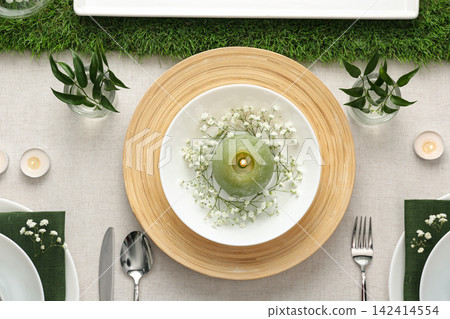 Elegant table setting with green plants on light cloth, flat lay 142414554