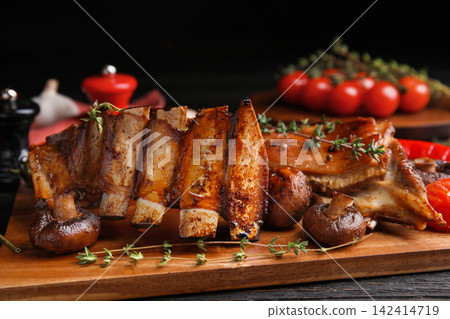 Delicious roasted ribs served on table, closeup Delicious roasted ribs served on table, closeup 142414719
