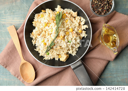 Delicious chicken risotto served on light blue wooden table, flat lay Delicious chicken risotto served on light blue wooden table, flat lay 142414728