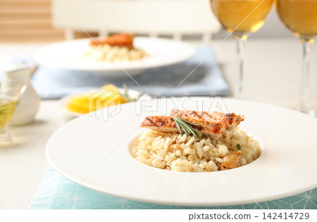Delicious chicken risotto served on table, closeup Delicious chicken risotto served on table, closeup 142414729