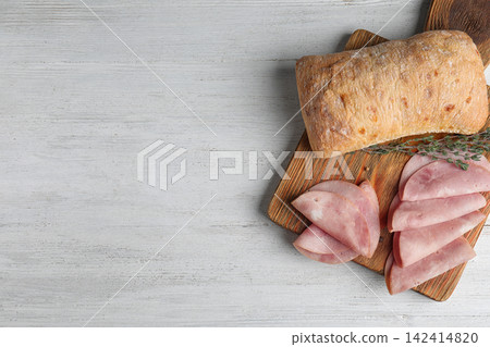 Tasty ham served on white wooden table, flat lay. Space for text Tasty ham served on white wooden table, flat lay. Space for text 142414820