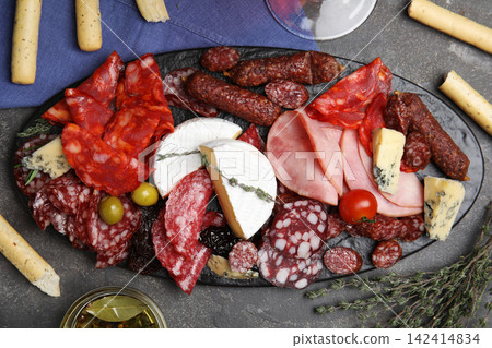 Tasty ham with other delicacies served on grey table, flat lay Tasty ham with other delicacies served on grey table, flat lay 142414834