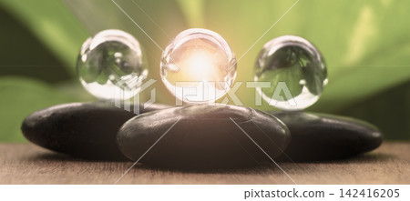 Illuminated zen stones symbolizing enlightenment and positive energy, with customizable space for text. Illuminated zen stones symbolizing enlightenment and positive energy, with customizable space for text. 142416205