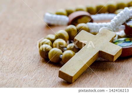 Close up view of Holy Rosary on wooden table. Religion concept. Close up view of Holy Rosary on wooden table. Religion concept. 142416213