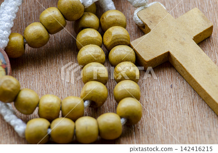Close up view of wooden Holy Rosary on wooden table with customizable space for text. Religion concept. Close up view of wooden Holy Rosary on wooden table with customizable space for text. Religion concept. 142416215
