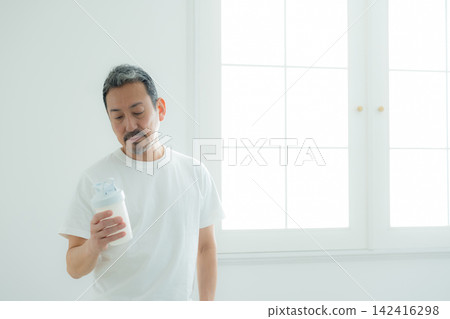 Senior man drinking protein Senior man drinking protein 142416298