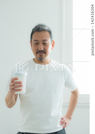 Senior man drinking protein Senior man drinking protein 142416304