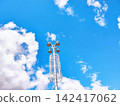 Modern Industrial Streetlight against a Cloud-filled Blue Sky 142417062