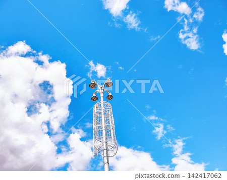 Modern Industrial Streetlight against a Cloud-filled Blue Sky Modern Industrial Streetlight against a Cloud-filled Blue Sky 142417062