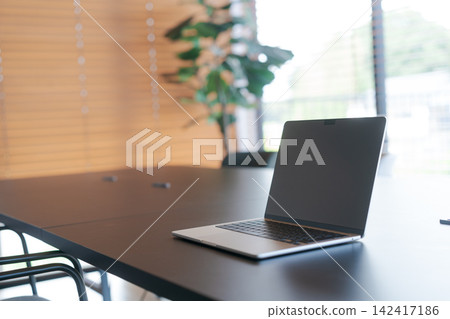 A laptop computer placed on a cafe table A laptop computer placed on a cafe table 142417186